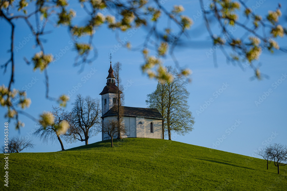 Beautiful landscape around St. Thomas church in Skofja Loka hills on spring evening