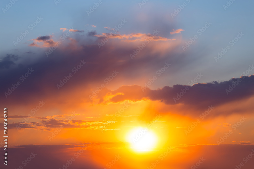 Fototapeta premium dramatic sunset over a cloudy sky, natural outdoor background