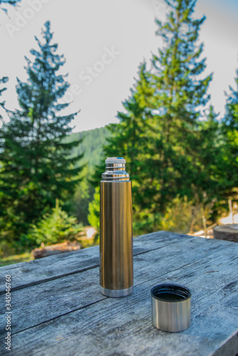 thermos on picnic in the mountains in the forest on nature
