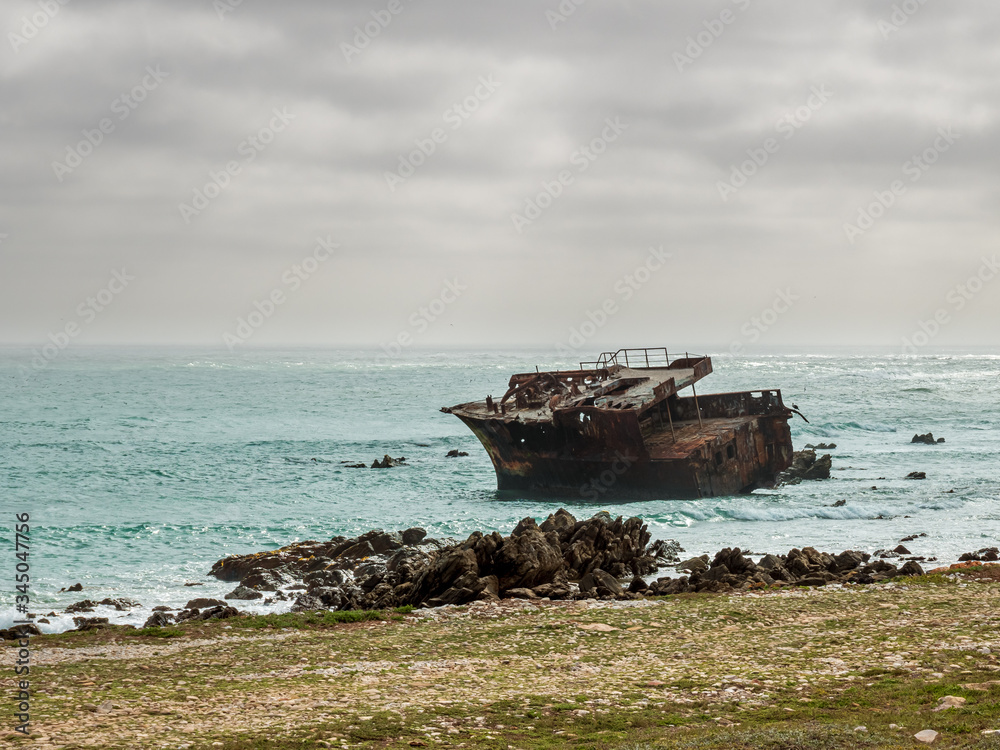 South Africa Ship wreck with cloudy sky and turquoise water background South Africa Ship wreck with cloudy sky and turquoise water background
