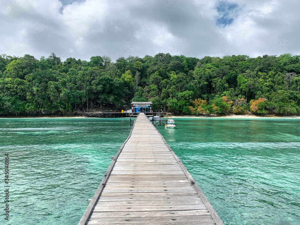 Kakaban Island, North Kalimantan, Indonesia pier over beautiful turquoise water.  Leisure and Travel
