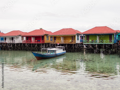 Colorful water cottages and boats at Derawan Island, North Kalimantan, Indonesia. Leisure and travel.
