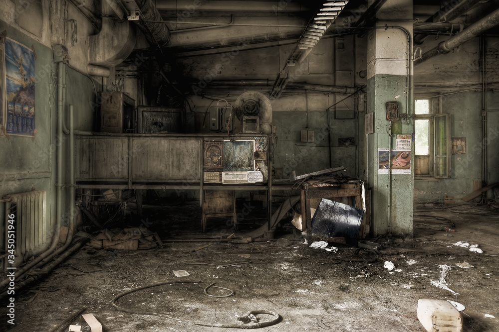 Hall with old and broken equipment in an abandoned workshop Hall with old and broken equipment in an abandoned workshop