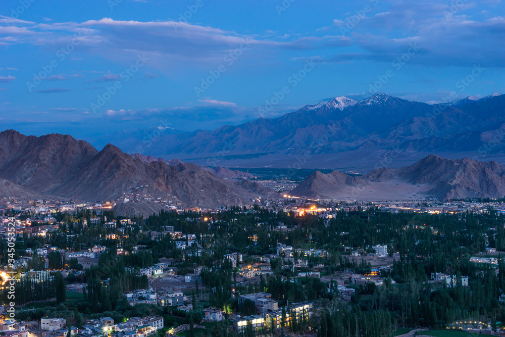 Leh city at night in summer season surrounded by Himalaya mountains range in Ladakh region, Northern India