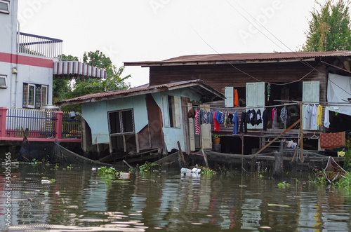 Stilt houses at a klong in Bangkok. Klongs are the canals, that branch off from Chao Phraya river, the big river of Bangkok. The klong is the only way to get to these houses.