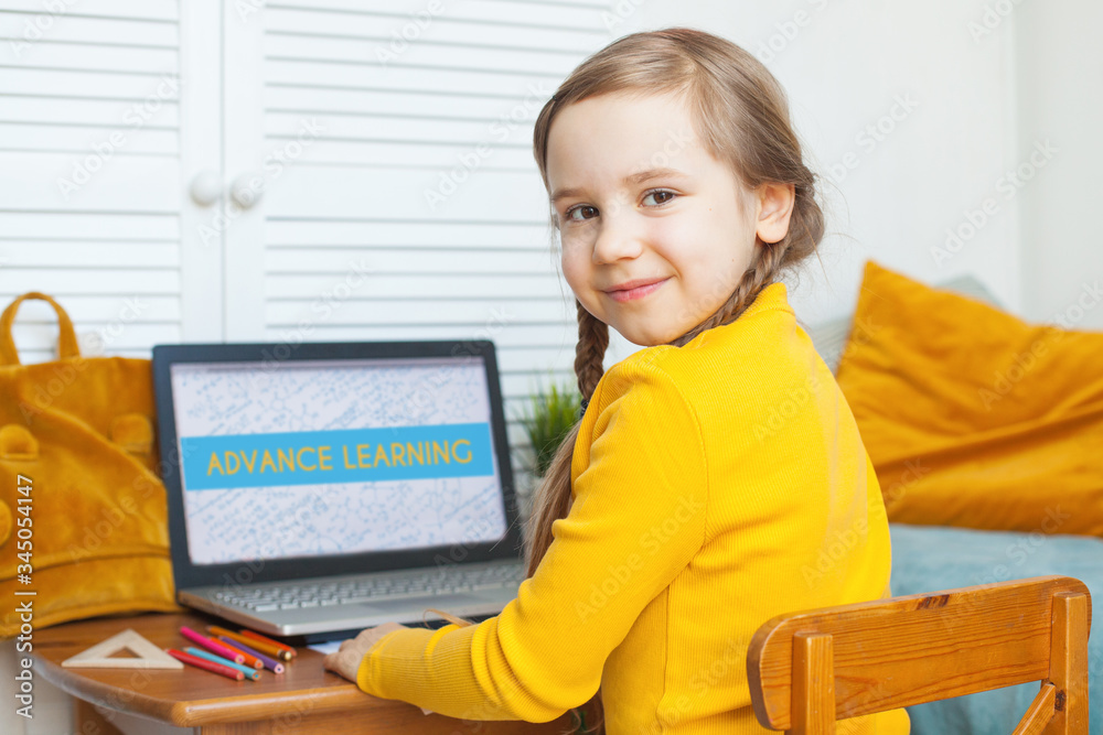 Smiling child girl at home. Little girl with laptop Stock Photo | Adobe ...