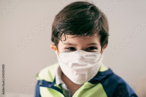 four years old boy with facial mask portrait photo