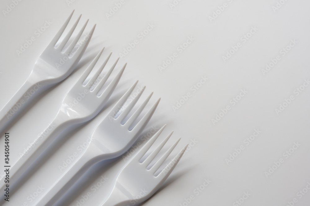 Four plastic forks isolated on white background. Copy space.. Four plastic forks isolated on white background. Copy space..