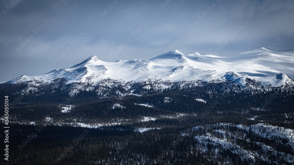 Winter landscape with dramatic snowy mountains.