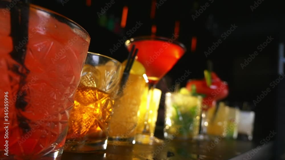 Cocktail Drinks Lined Up on a Bar Table During a Night Party