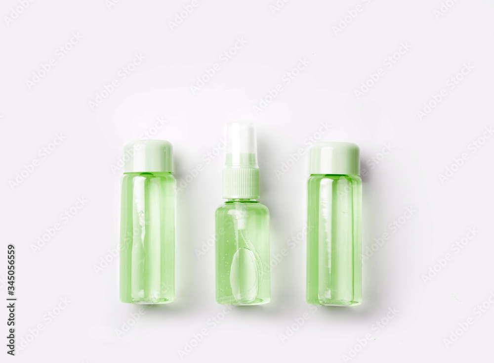 Three bottles of hand sanitizer. Liquid soap and sanitizer for hands on greenbackground. Stay home and stay safe. Self care and antivirus security. Hand disinfection. Measures to avoid infection. Three bottles of hand sanitizer. Liquid soap and sanitizer for hands on greenbackground. Stay home and stay safe. Self care and antivirus security. Hand disinfection. Measures to avoid infection.