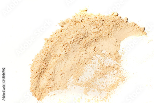 Whitening Mineral Loose Powder.Scattered tan colored facial loose powder on white background.