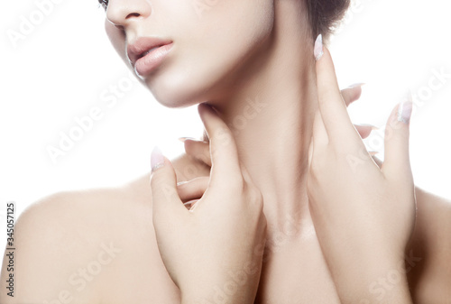 Partial beauty portrait of young woman with perfect skin touching neck with sensual hands. Facial treatment skincare health concept