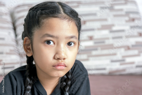 A little Asian girl in a black braid