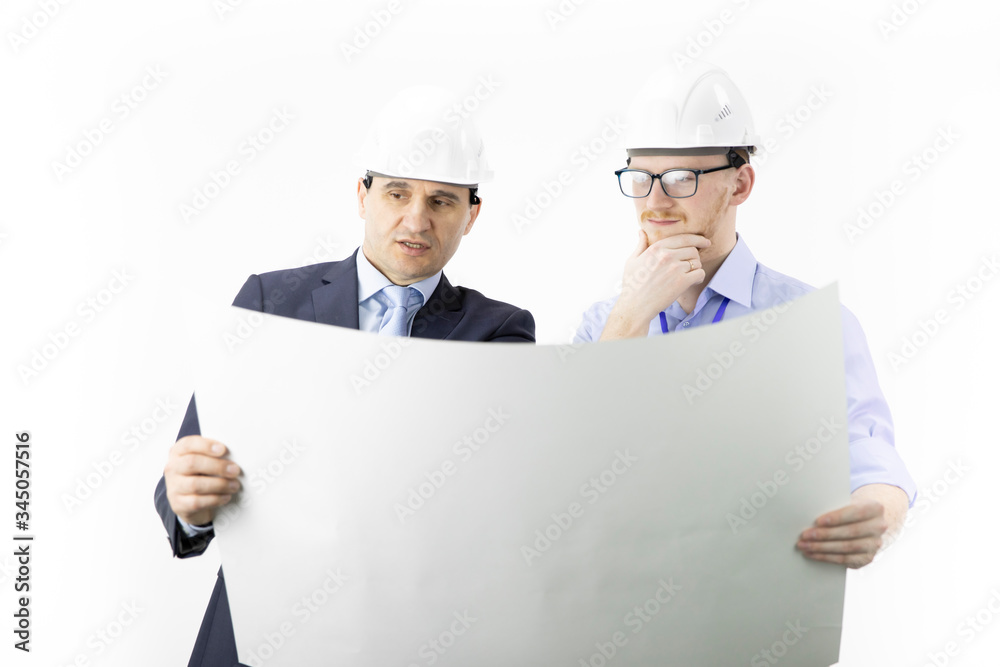Engineers reading instructions. Engineer and businessman meeting, team work discussion. Head of project and chief engineer planing, measuring layout of building blueprint isolated on white background Engineers reading instructions. Engineer and businessman meeting, team work discussion. Head of project and chief engineer planing, measuring layout of building blueprint isolated on white background