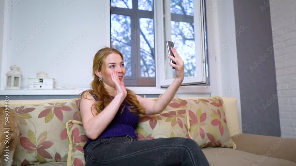 Young woman having a video call through a tablet, talking to mom. friends, facetime, online, internet, long distance communication, chat concepts. Skype talking with grandma Young woman having a video call through a tablet, talking to mom. friends, facetime, online, internet, long distance communication, chat concepts. Skype talking with grandma