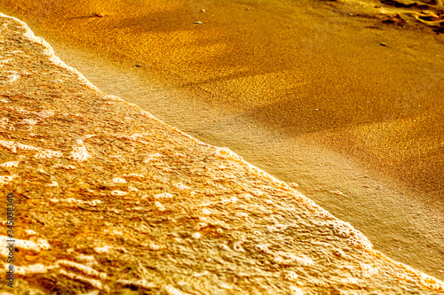 Summer. Sea. Sandy beach and fine sand. Small waves. Background.
