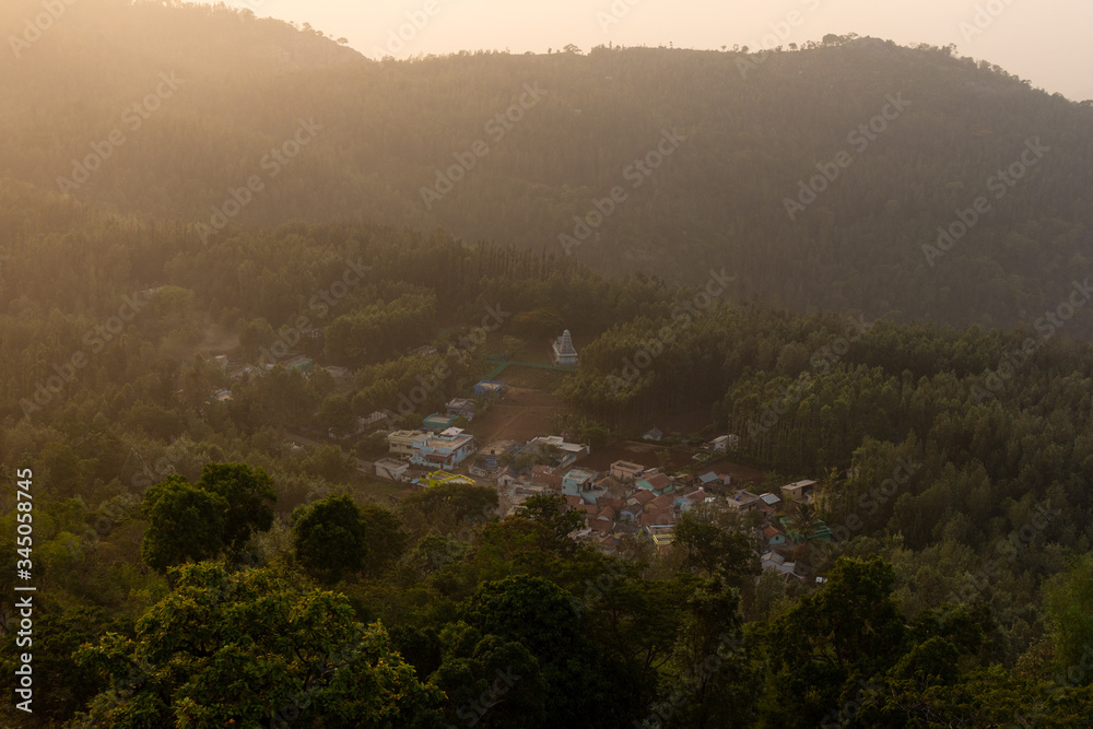 Aerial view of a village in the mountain valley during sunrise.
