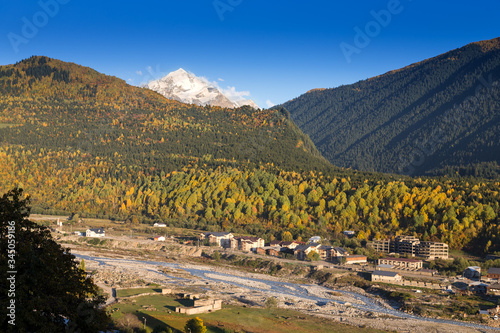 View of the village in a beautiful autumn landscape with white clouds in Svaneti. Georgia photo