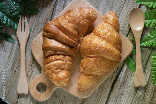 Tasty buttery croissants on  wooden table