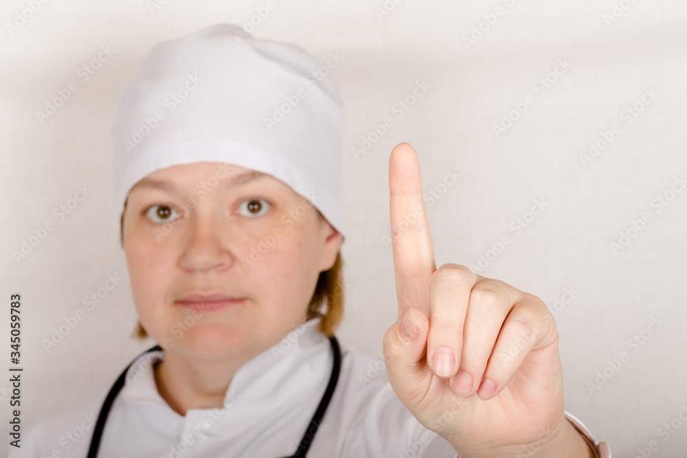 Female doctor with phonendoscope on her neck shows you some sign for preventation Female doctor with phonendoscope on her neck shows you some sign for preventation