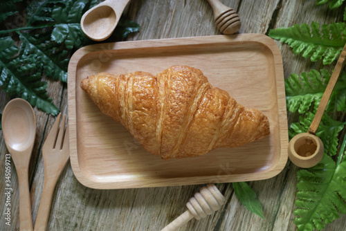 Tasty buttery croissants on  wooden table