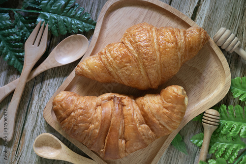 Tasty buttery croissants on  wooden table