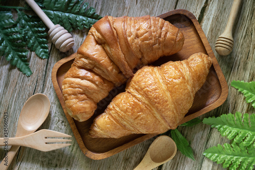 Tasty buttery croissants on  wooden table