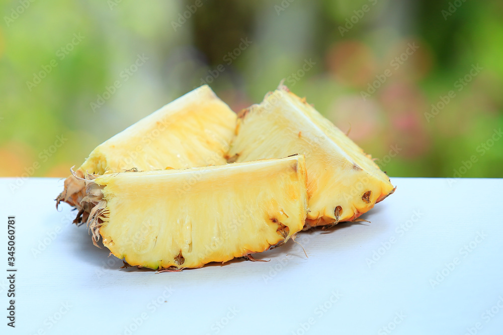 Sliced pineapple in the banana leaf isolated on blended green background Sliced pineapple in the banana leaf isolated on blended green background