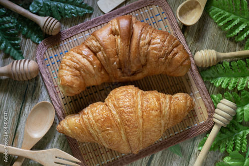Tasty buttery croissants on  wooden table