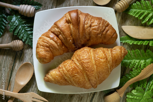 Tasty buttery croissants on  wooden table