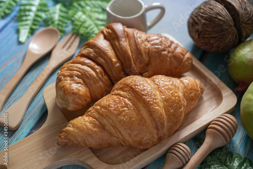 Tasty buttery croissants on  wooden table