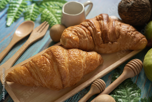 Tasty buttery croissants on  wooden table