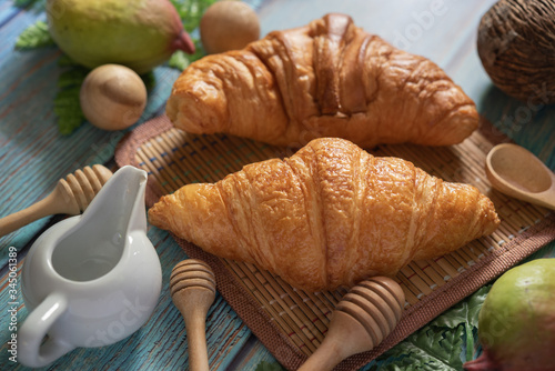 Tasty buttery croissants on  wooden table