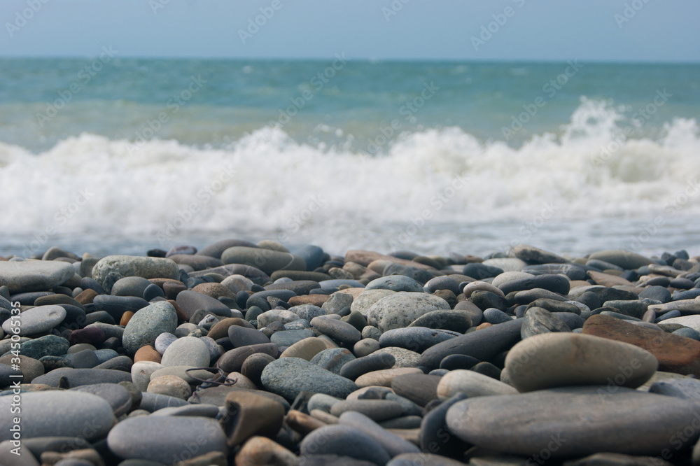 A small storm three or four points at sea, the wave hits the shore with a large pebble. A small storm three or four points at sea, the wave hits the shore with a large pebble.