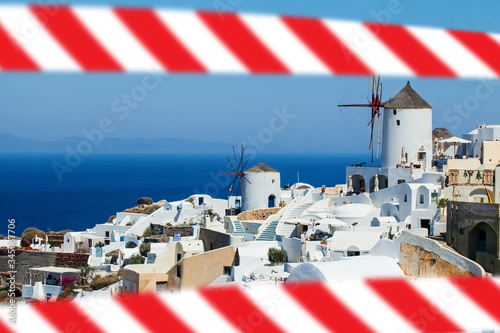 Fototapeta Naklejka Na Ścianę i Meble -  Santorini island landscape with warning tape. Closed historical european sightseeing, delayed vacation