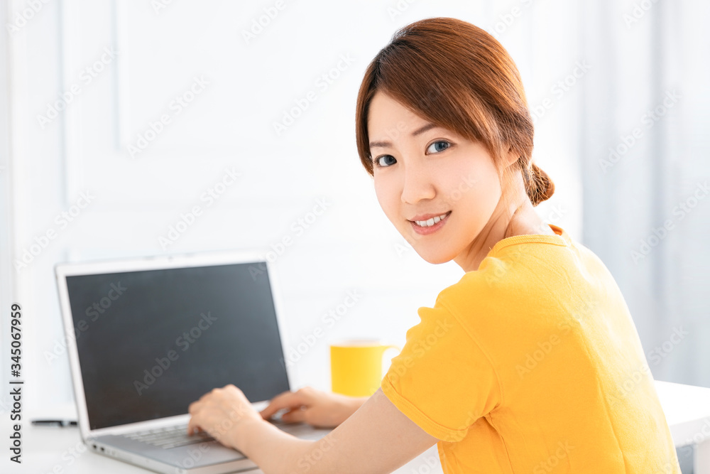 smiling young Woman working on laptop at home smiling young Woman working on laptop at home