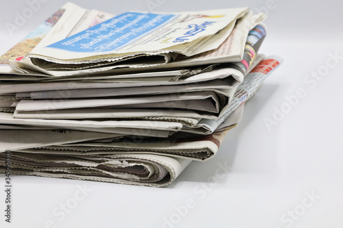 Pile of newspapers stacks on blur background
 photo