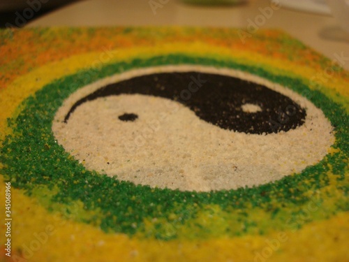 The symbol of yin yang. Harmony of masculine and feminine. Black and white. Two opposites. Handwork. Close-up. Mascot. Amulet.White and black dots. Man and woman.