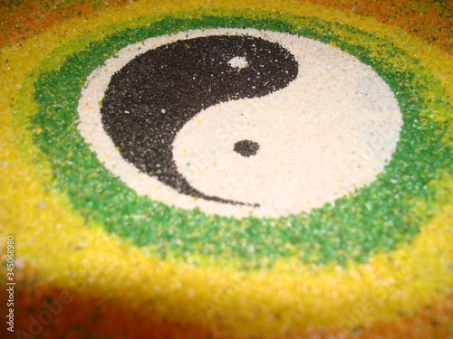 The symbol of yin yang. Harmony of masculine and feminine. Black and white. Two opposites. Handwork. Close-up. Mascot. Amulet.