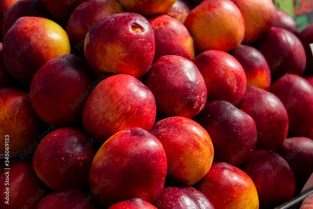 juicy red-yellow nectarines on counter of farmers' market selective focus. Fruit is a source of vitamins and health. concept of strengthening immunity by nature juicy red-yellow nectarines on counter of farmers' market selective focus. Fruit is a source of vitamins and health. concept of strengthening immunity by nature