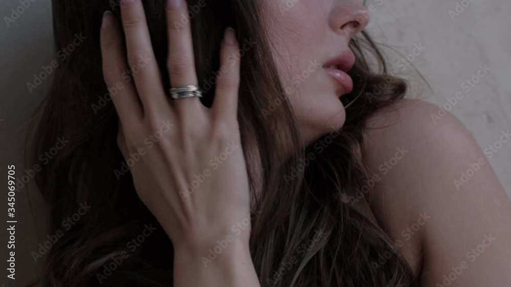 The girl with the stings in her hands touches her hair close-up. The girl with the stings in her hands touches her hair close-up.