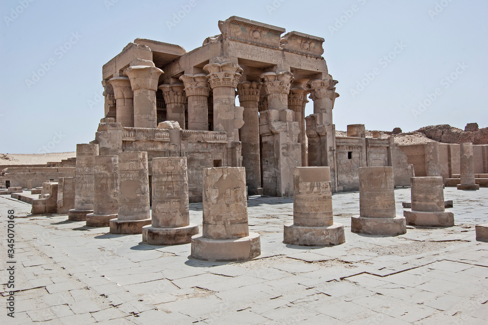 Columns and entrance to an ancient egyptian temple wall