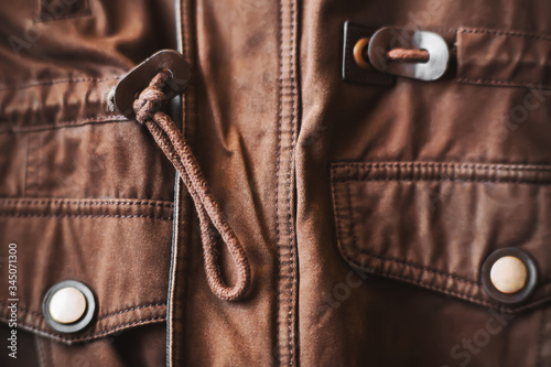 Winter warm brown jacket made of soft pleasant fabric with shiny buttons close-up. ©  Valeri Vatel
