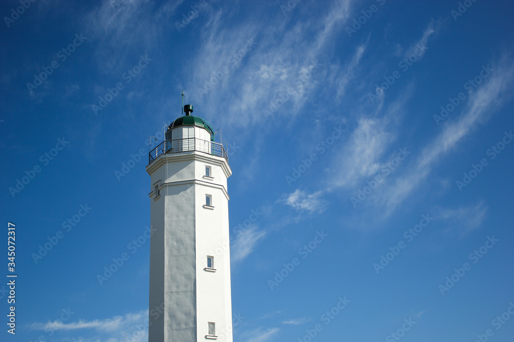 lighthouse on the beach with blue sky