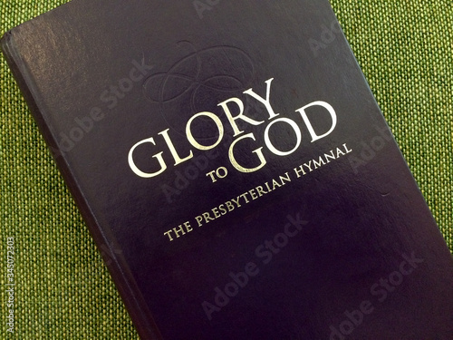 presbyterian glory of god hymnal book on green photo