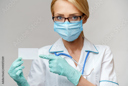 Doctor or woman nurse showing blank empty card with copy space