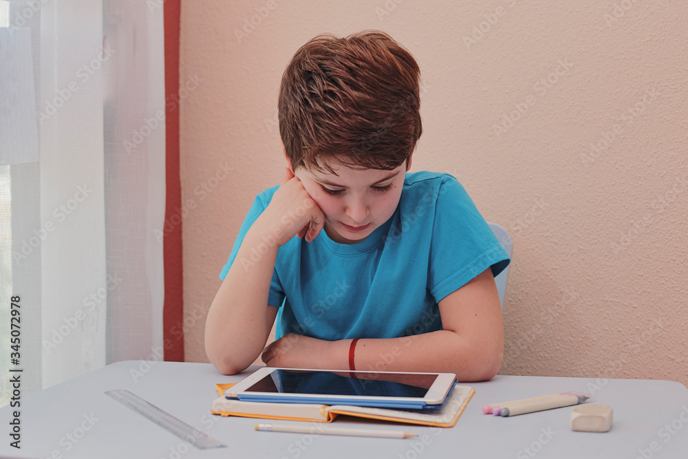 child studying at home using a tablet child studying at home using a tablet