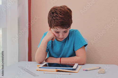 child studying at home using a tablet