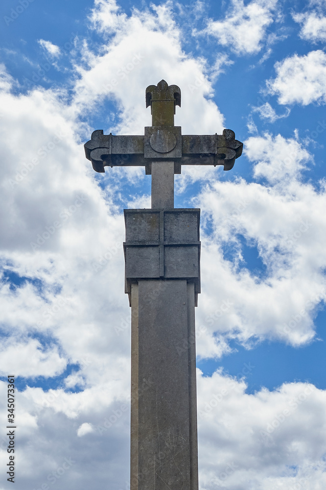 stone cross over cloudy sky